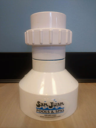 White cone shaped PVC plumbing fitting. The base is larger and the diameter decreases as it extends upward. At the base is a label for San Juan Pools & Spas. On top of the cone is a threaded union on which a Hayward Turbo Cell can be attached. This allows the Turbo Cell to be stood in an upright position for acid washing purposes.