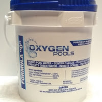 This product by Oxygen Pools is packaged in a ten pound white bucket with a blue lid.  Blue writing on the bucket matches its lid and says its a “precision blend” and “weekly additive”.  This product also shocks pool water, controls algae, clears cloudy water, prevents green water and inhibits scaling.  Vertical writing on the bucket’s left says “Formula O”.  The list of ingredients are given as well as a bold caution for children.